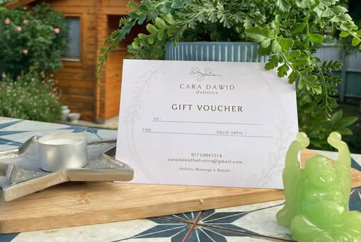A beautifully wrapped gift voucher with a dried flower.
